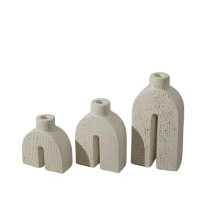 Set of three ceramic vases with textured surfaces on a white background